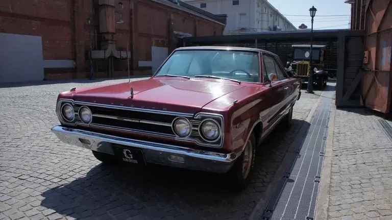 A red 1967 Plymouth Satellite displayed outside the Glion Museum in Osaka, Japan