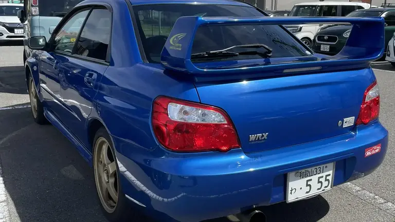 Back view of a rented blue Subaru Impreza WRX parked in Wakayama-shi, Japan