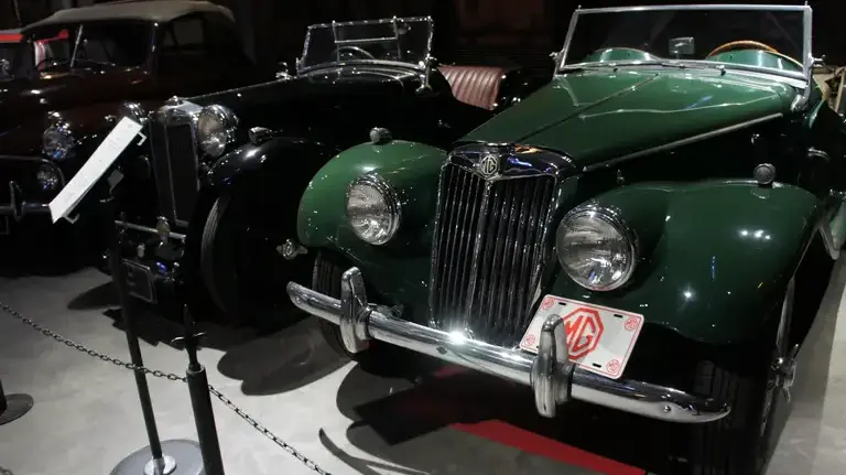 A green MG TF displayed inside the Glion Museum in Osaka, Japan