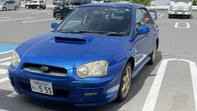 Front view of a rented blue Subaru Impreza WRX parked in Wakayama-shi, Japan
