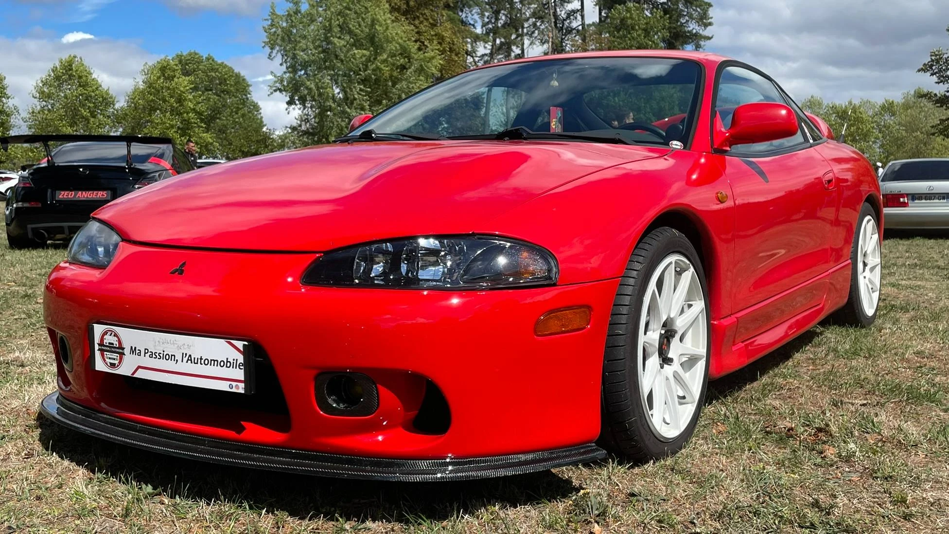 Front side view of a red Mitsubishi Eclipse