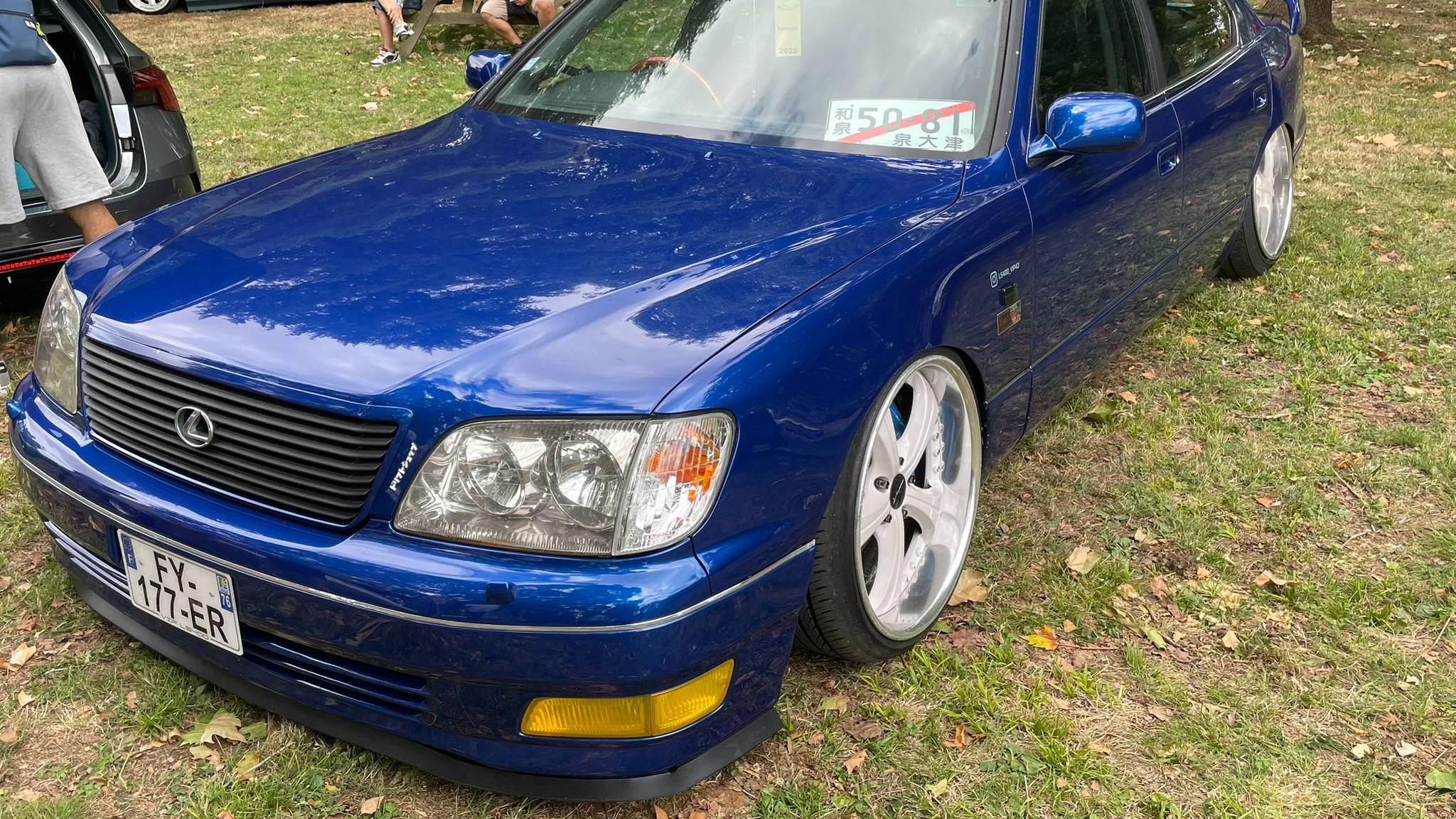 Front side view of a stanced deep blue Lexus LS400