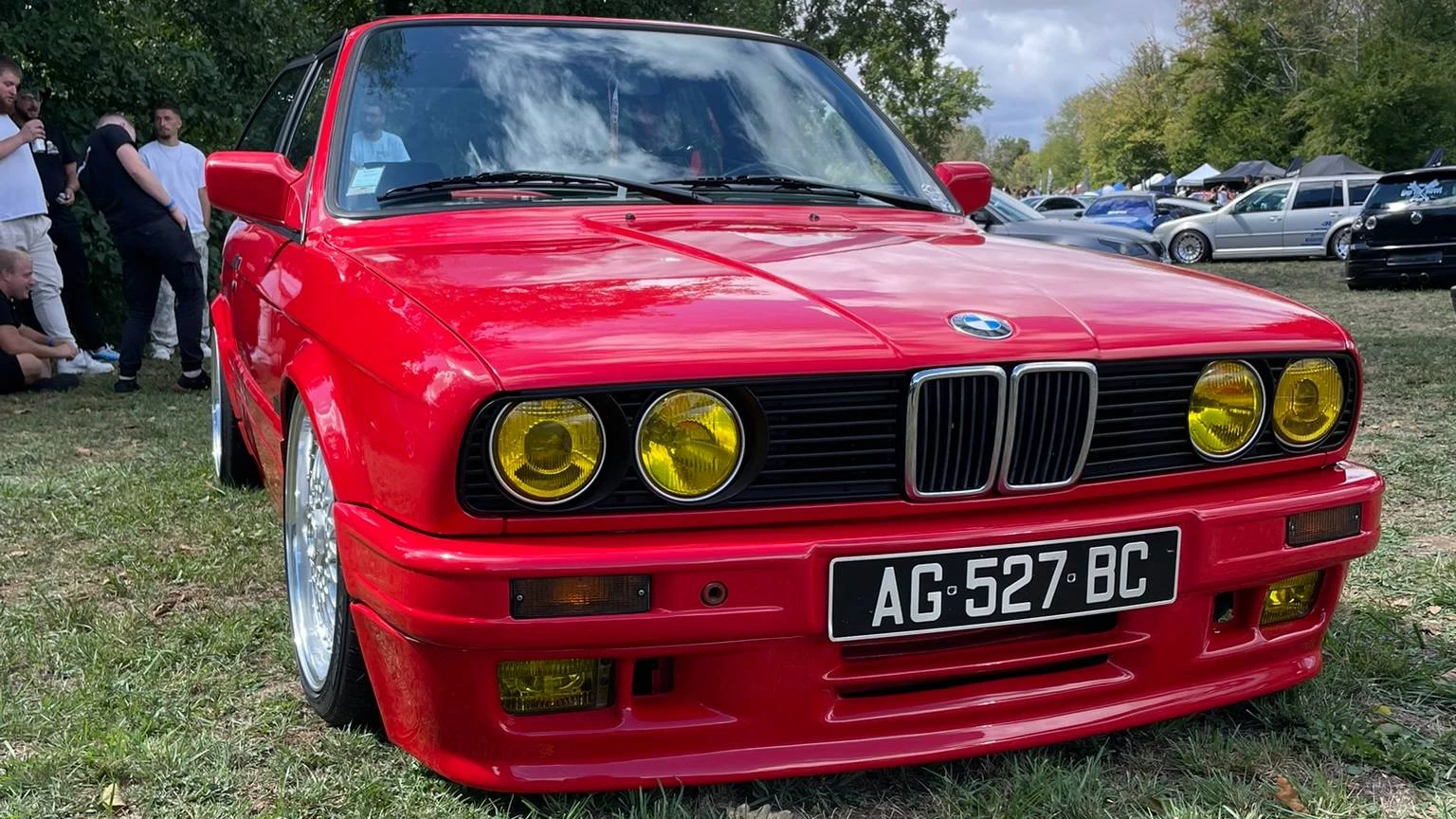 Front end view of a stanced red 1990 BMW 316i