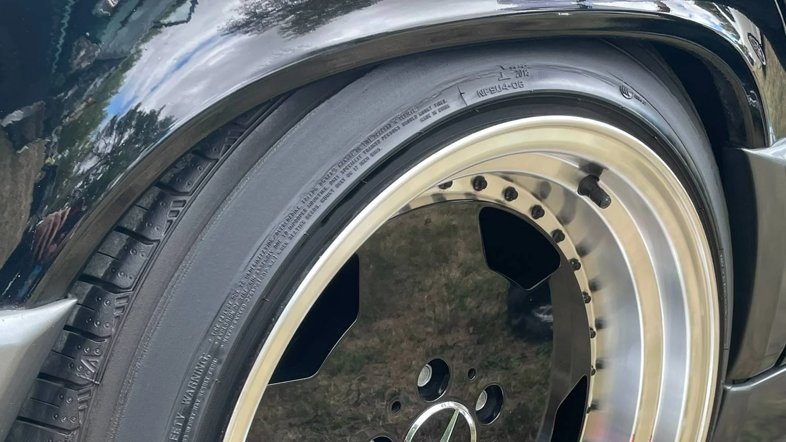 Close-up view of a stanced black mercedes-benz wheel arch
