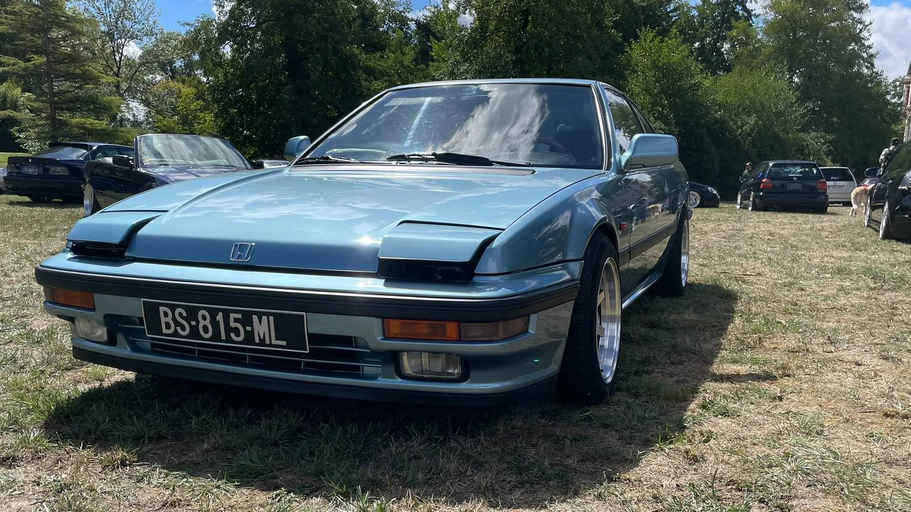 A stanced blue 1989 Honda Prelude