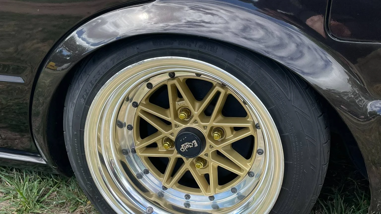 Close-up view of a stanced grey/black 1984 Nissan Bluebird wheel arch