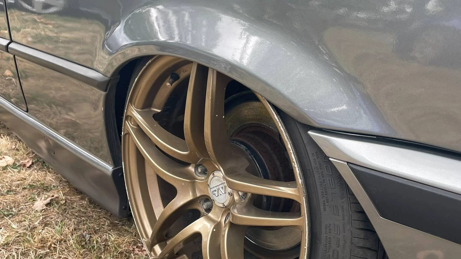 Close-up view of a stanced grey BMW wheel arch
