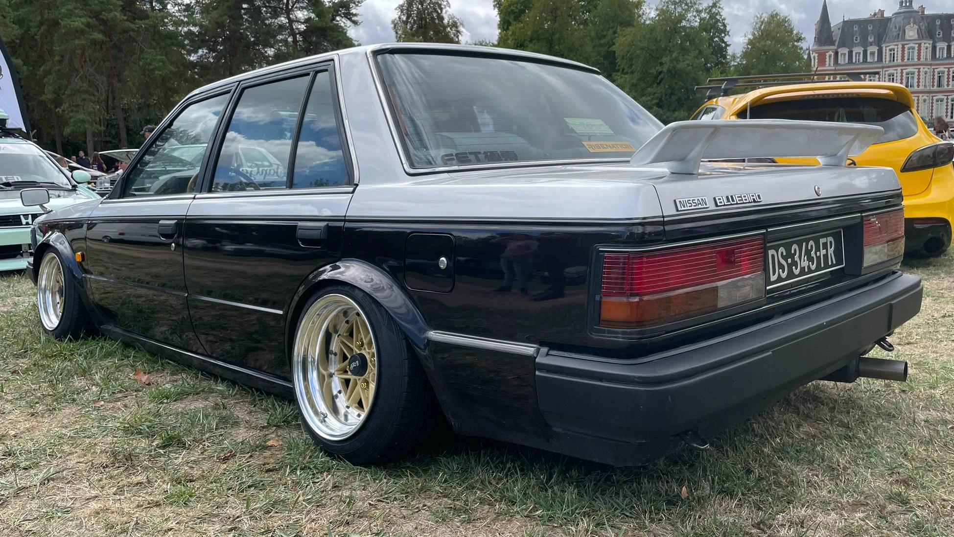 Back side view of a stanced 1984 grey/black Nissan Bluebird