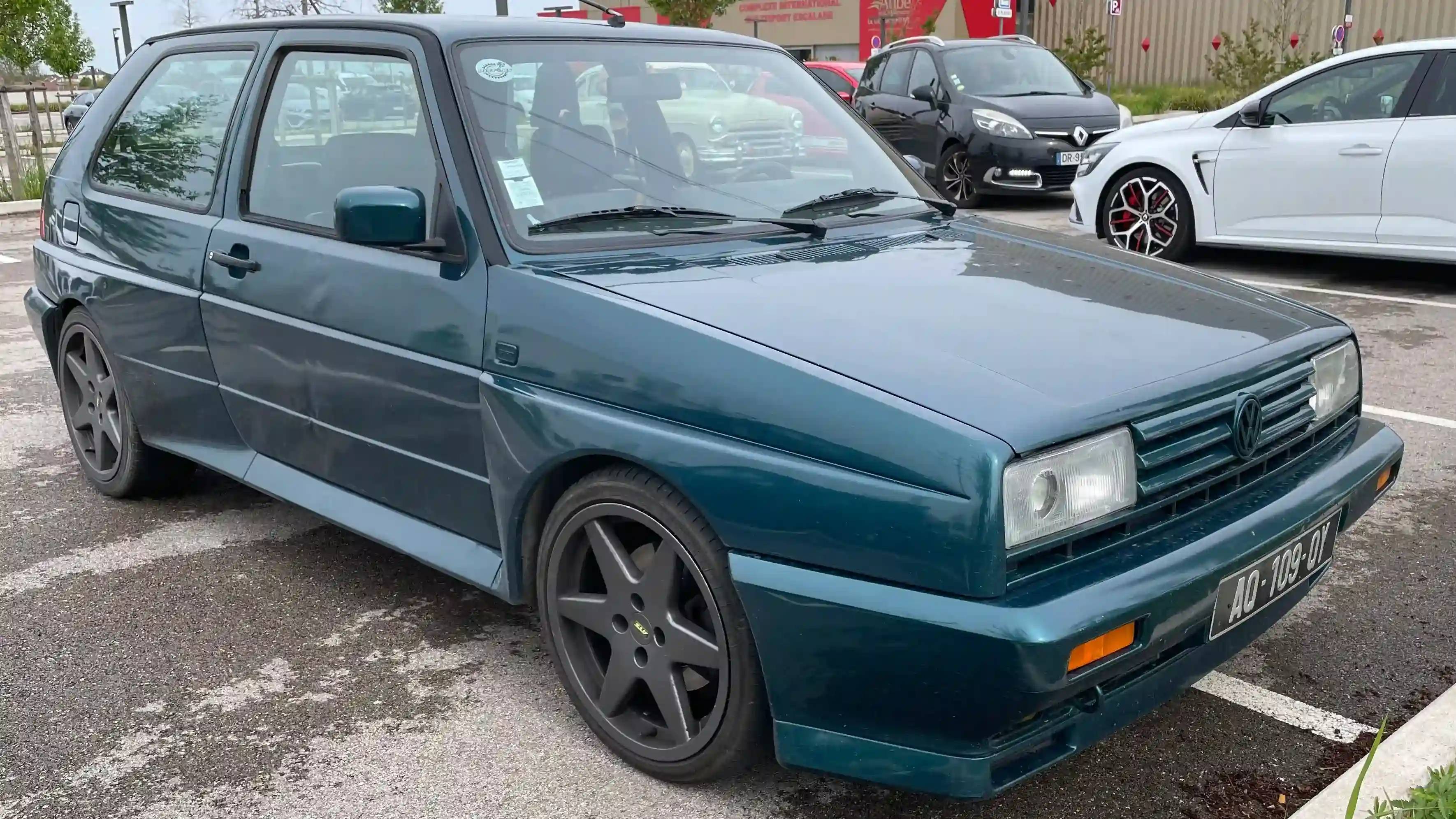 A parked dark teal Volkswagen Golf Rallye