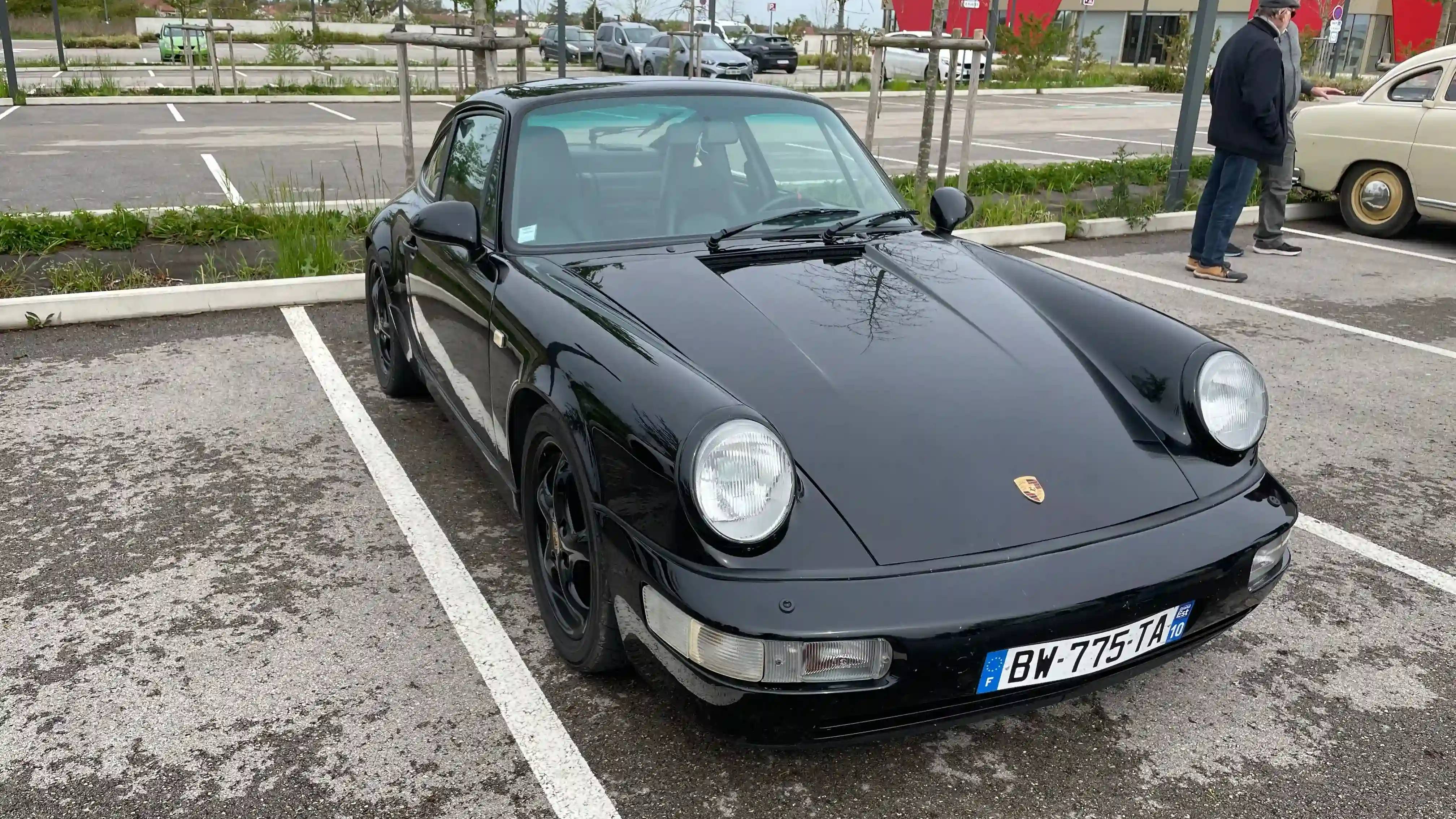 A parked black Porsche 964 Carrera 4