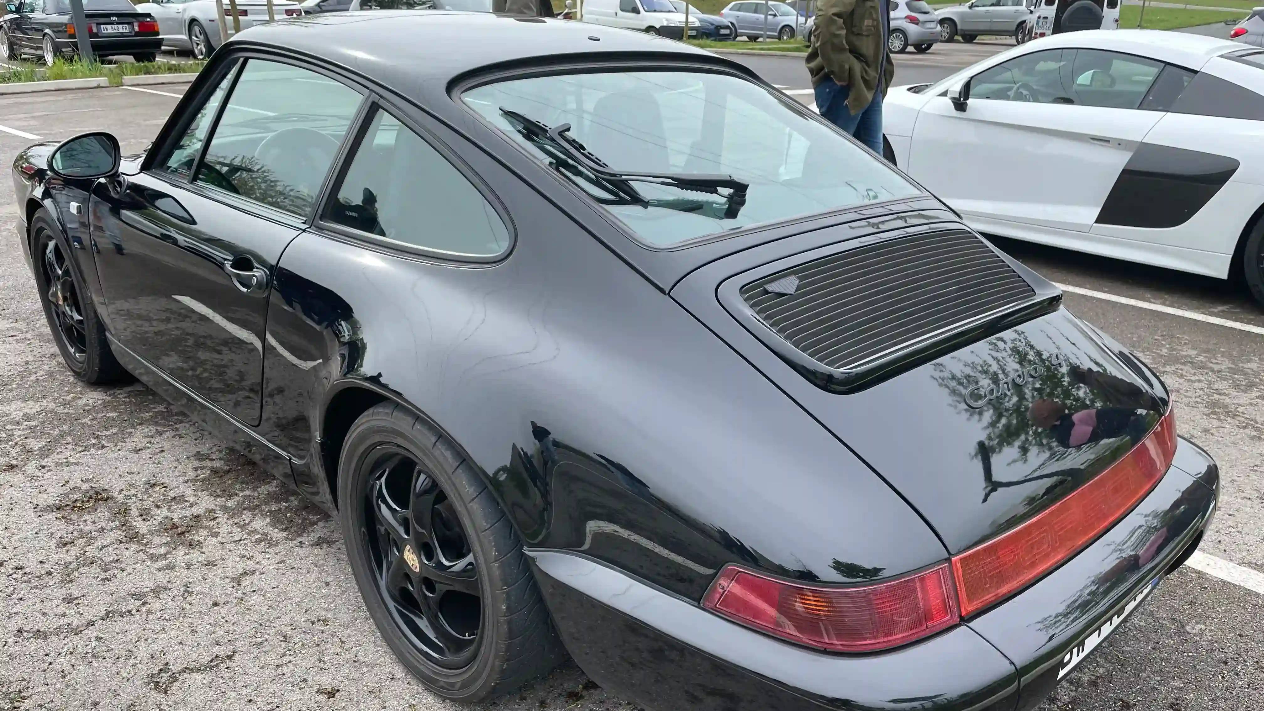 A parked black Porsche 964 Carrera 4