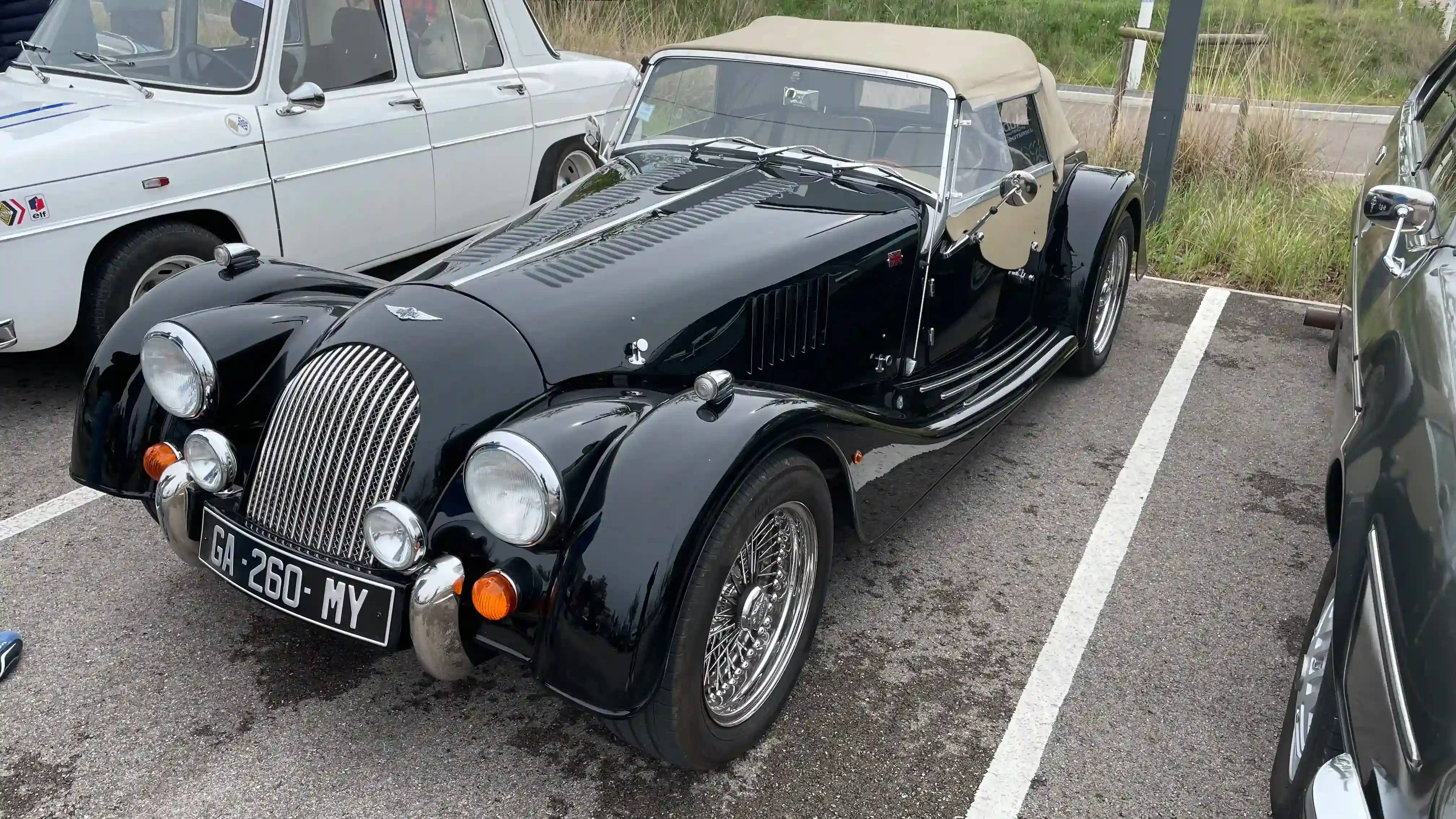 A parked black Morgan Plus 4