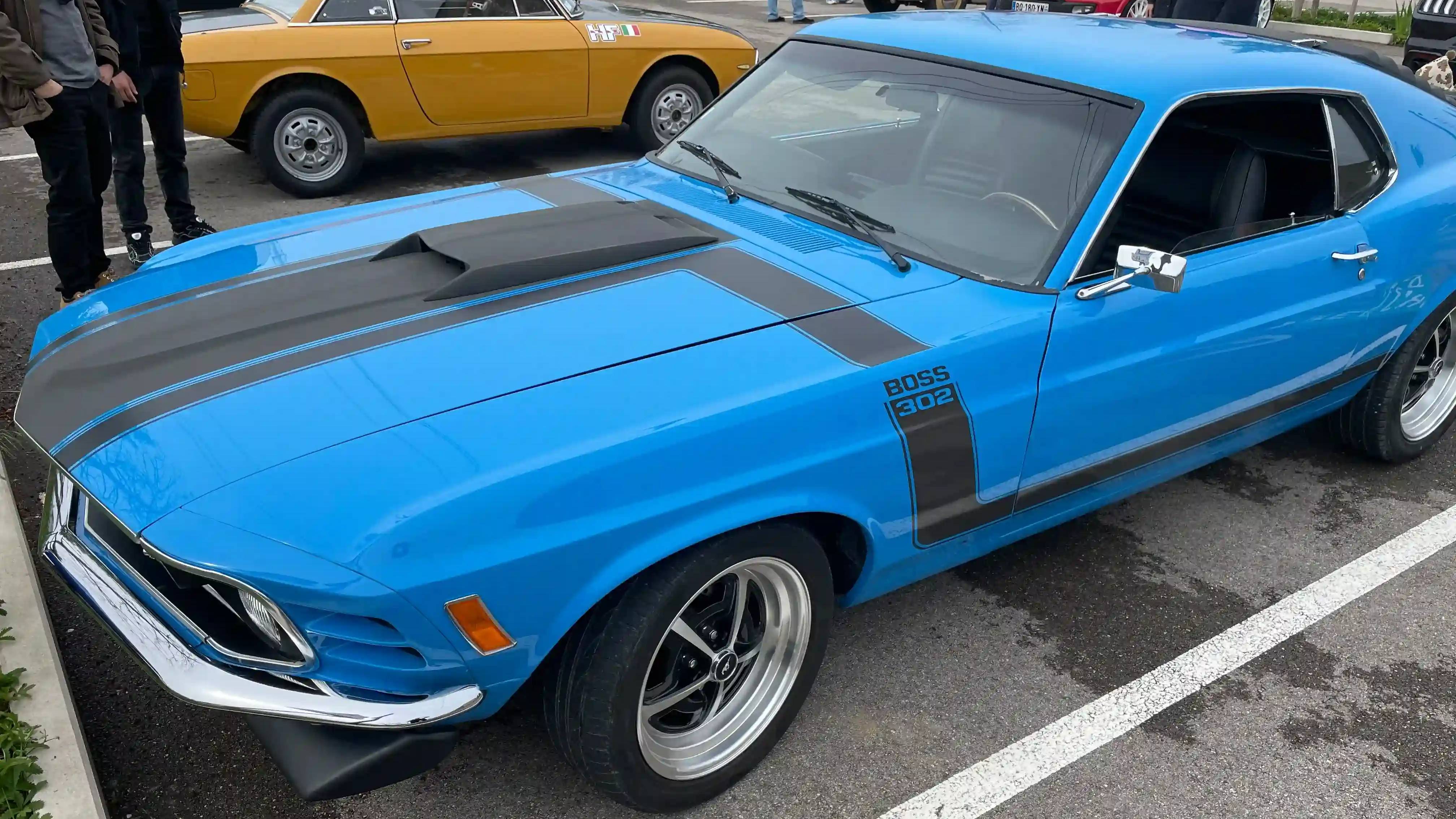 A blue 1970 Ford Mustang Boss 302 parked on the road