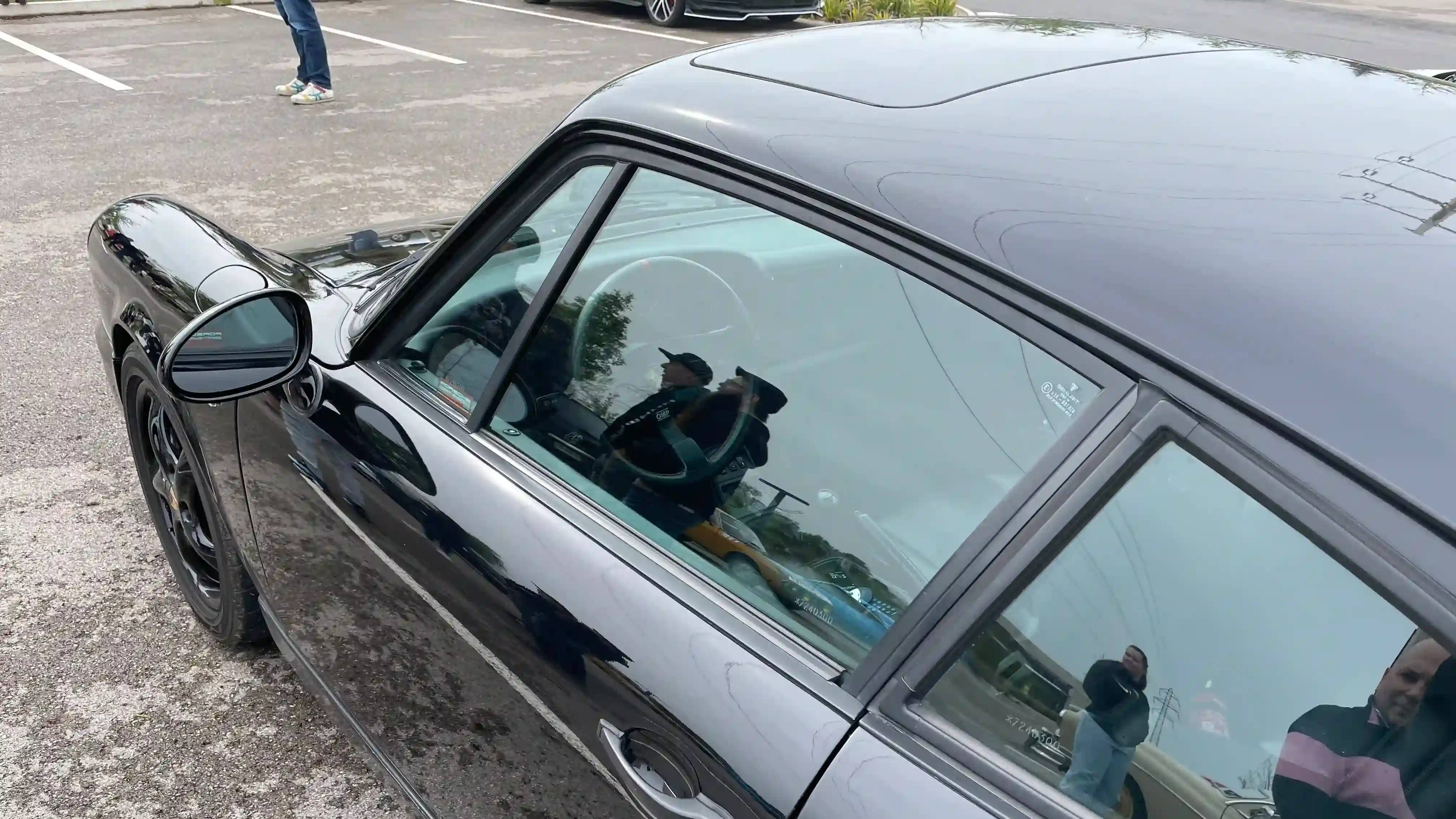 Side/interior view of a black Porsche 964 Carrera 4
