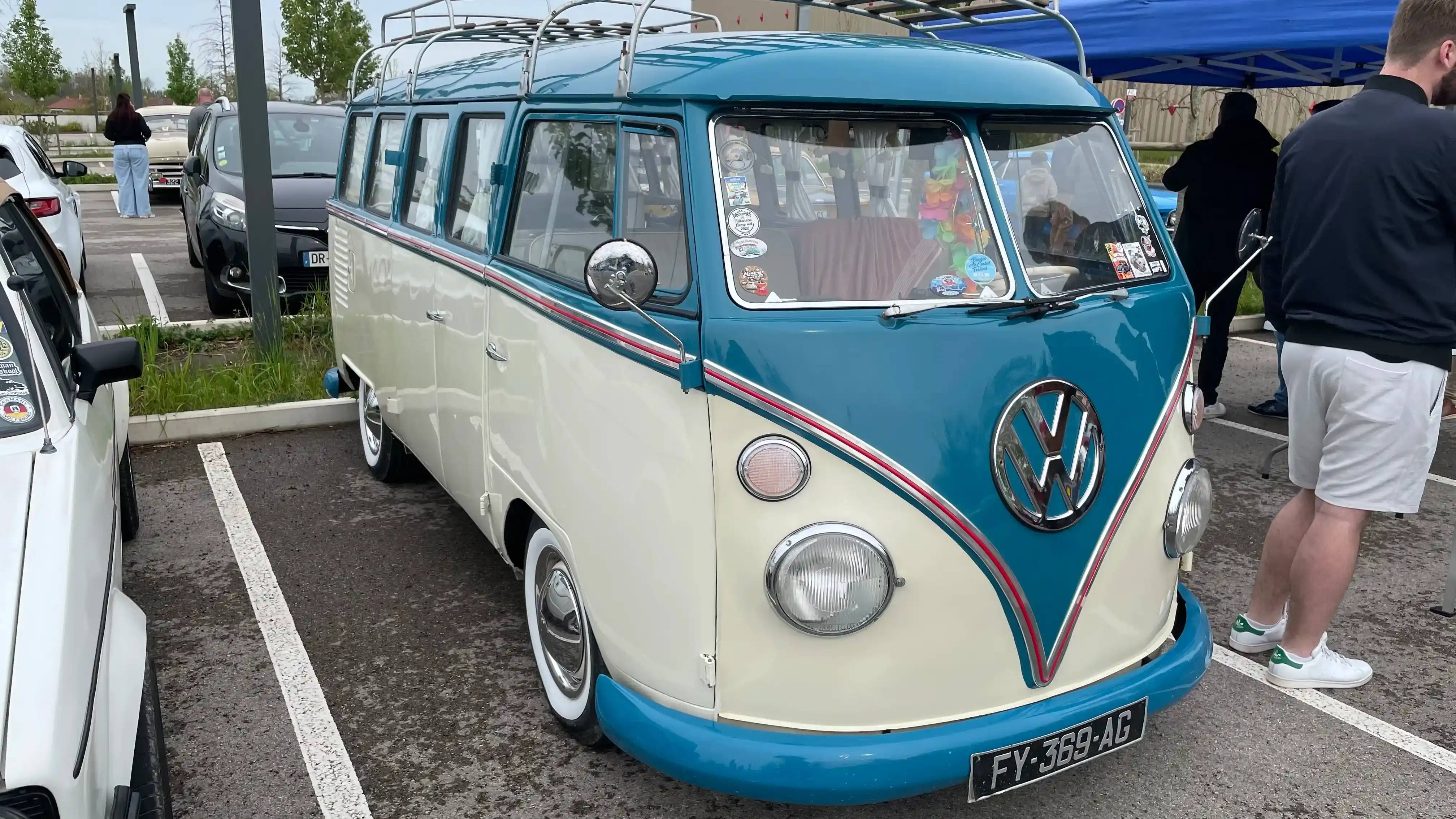 A parked white and blue Volkswagen Combi