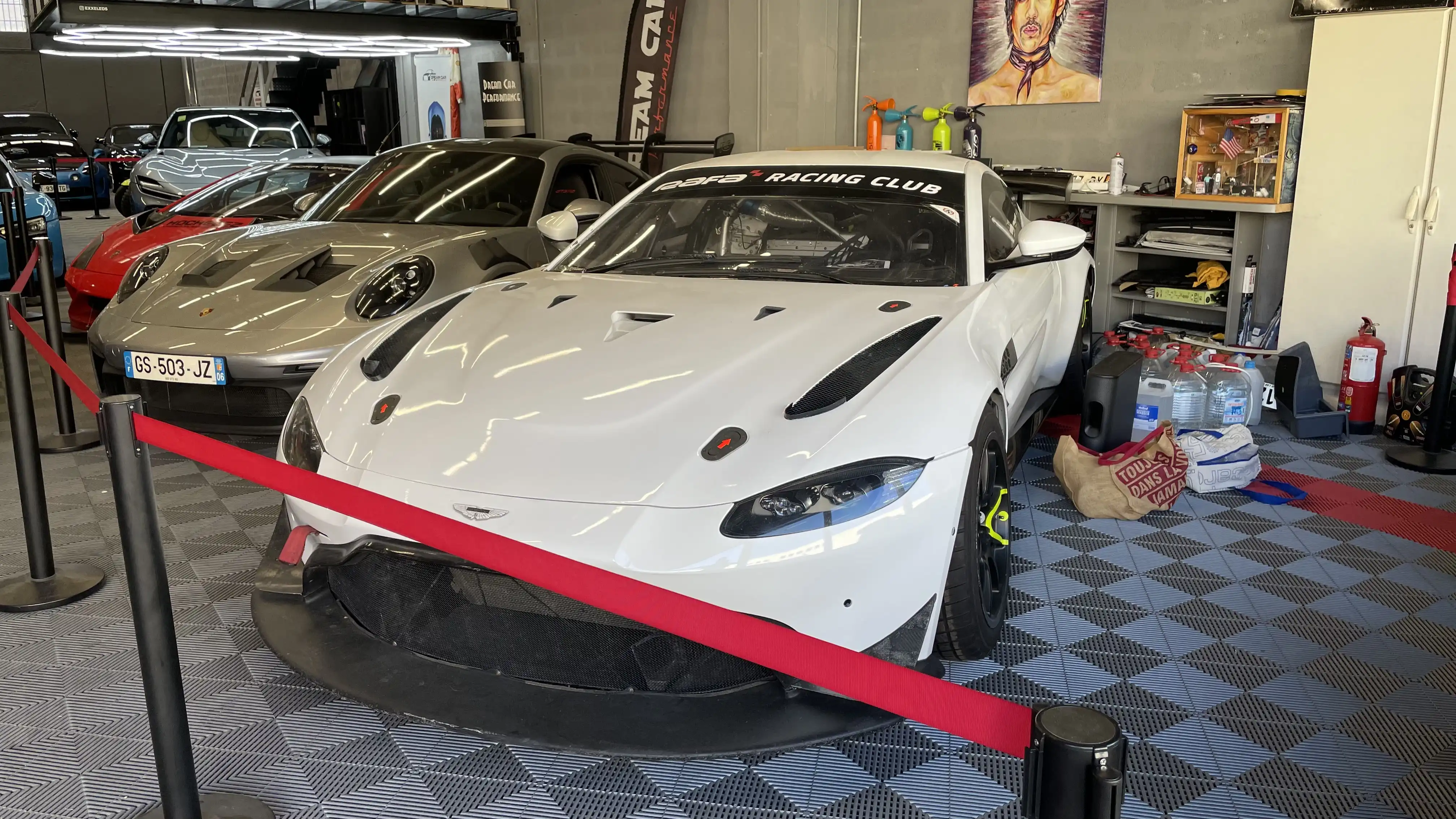 A white Aston Martin Vantage AMR GT4 17-A inside the showroom of Dream Car Performance
